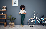 Tablet, bicycle and portrait of black woman in home web or internet browsing. Smile, relax and happy female from South Africa on digital touchscreen tech, mobile app or networking on social media.
