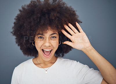 Buy stock photo Hand, wave and excitement with an afro black woman in studio on a gray background greeting with a smile. Portrait, hair and happy with an attractive young female waving to welcome or say hello