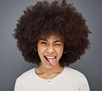 Goofy, face and woman with her tongue out in studio with comic, fun and crazy facial expression. Silly, funny and portrait of happy girl model from Puerto Rico standing and posing by gray background.