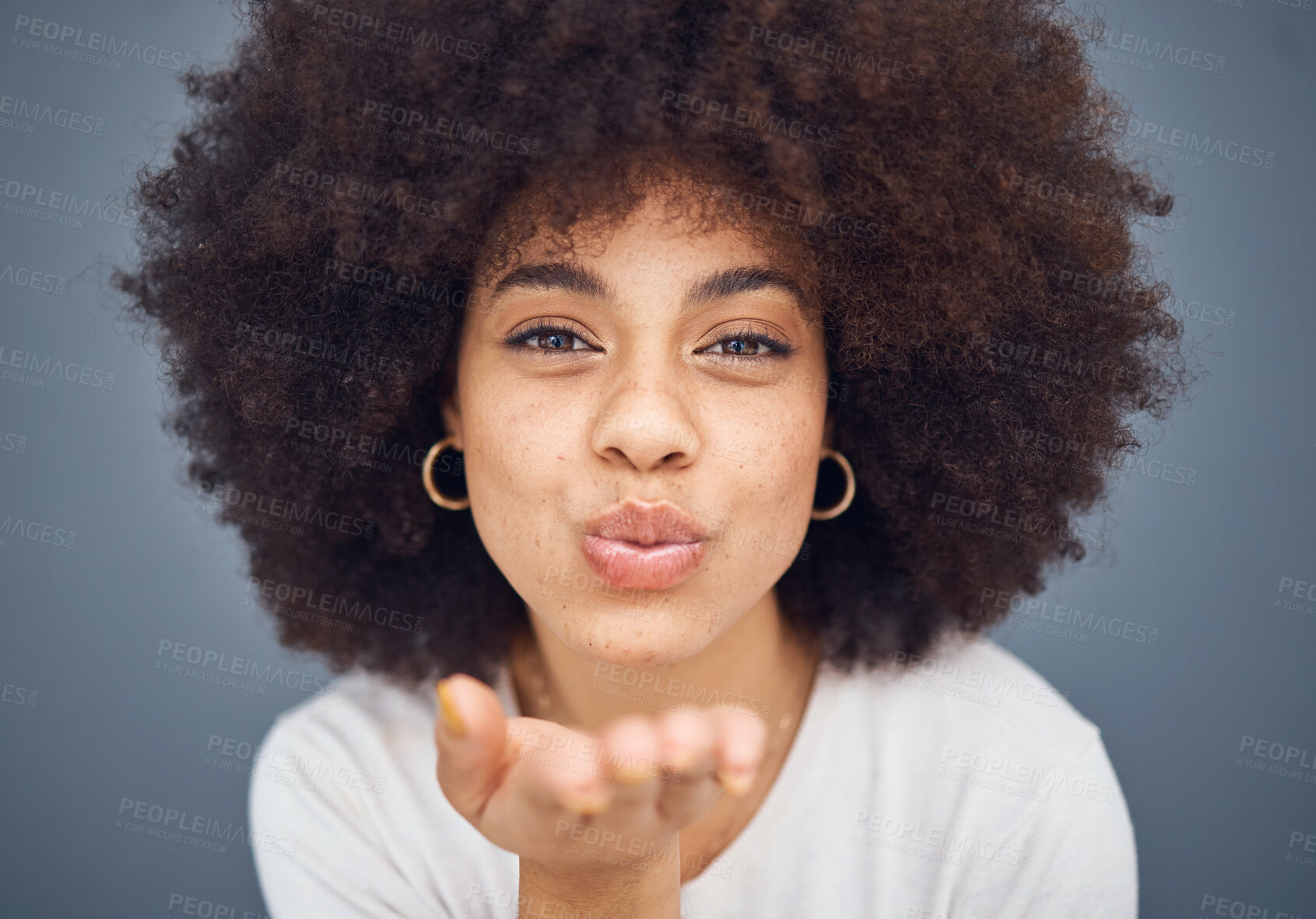 Buy stock photo Face, portrait and woman blowing a kiss on a grey studio background being flirty and seductive. Fun, flirting and beautiful african american female kissing and being alluring and isolated on backdrop