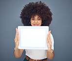 Tablet, mockup and display with a black woman in studio on a gray background for advertising or marketing. Space, product placement and technology with a female showing a blank screen for copyspace