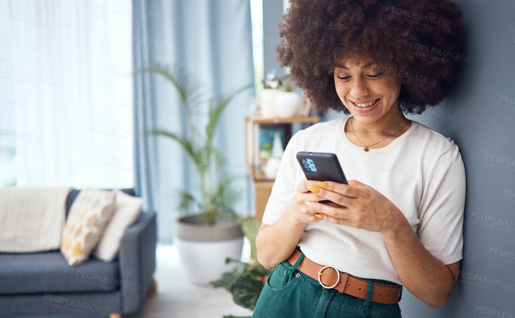 Buy stock photo Woman, funny social media phone and happy with online dating profile notification in living room. Young smile female with afro relax at home, smartphone connection and 5g mobile network technology
