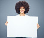 Woman, board and blank placard ready for marketing or advertising message on a grey studio background. Black female, poster and empty placard for advertisment, mockup or copyspcace sign