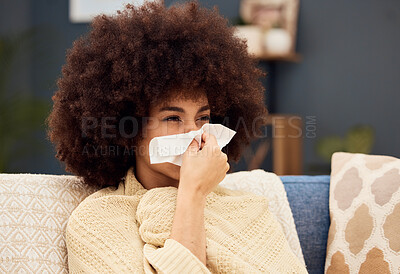 Buy stock photo Sick, sad and woman with covid blowing nose on the sofa with a blanket in the lounge of a house. Burnout, virus and African girl with a tissue to wipe nose with flu, cold or medical problem in home