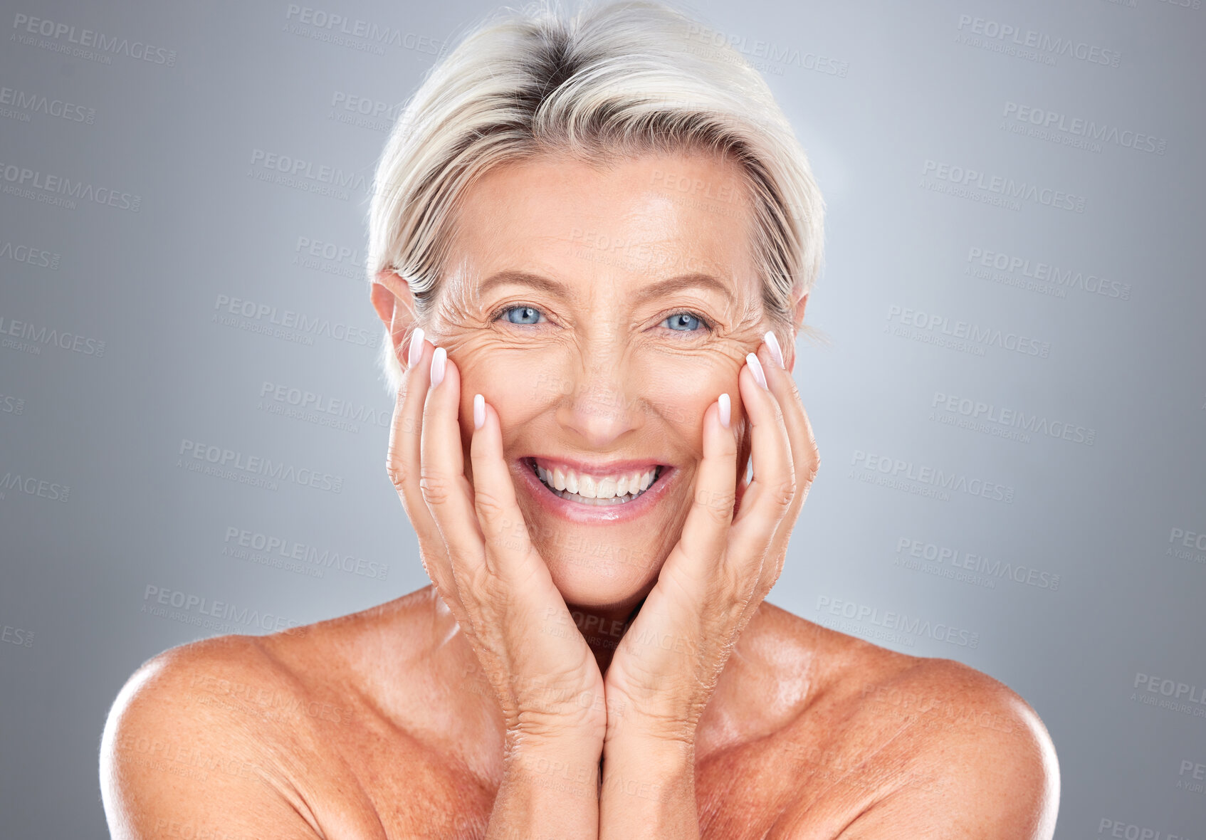 Buy stock photo Portrait, senior woman and beauty, skincare and wellness in studio for grooming, hygiene and pamper routine on grey background. Face, elderly model and happy, smile and excited about facial treatment