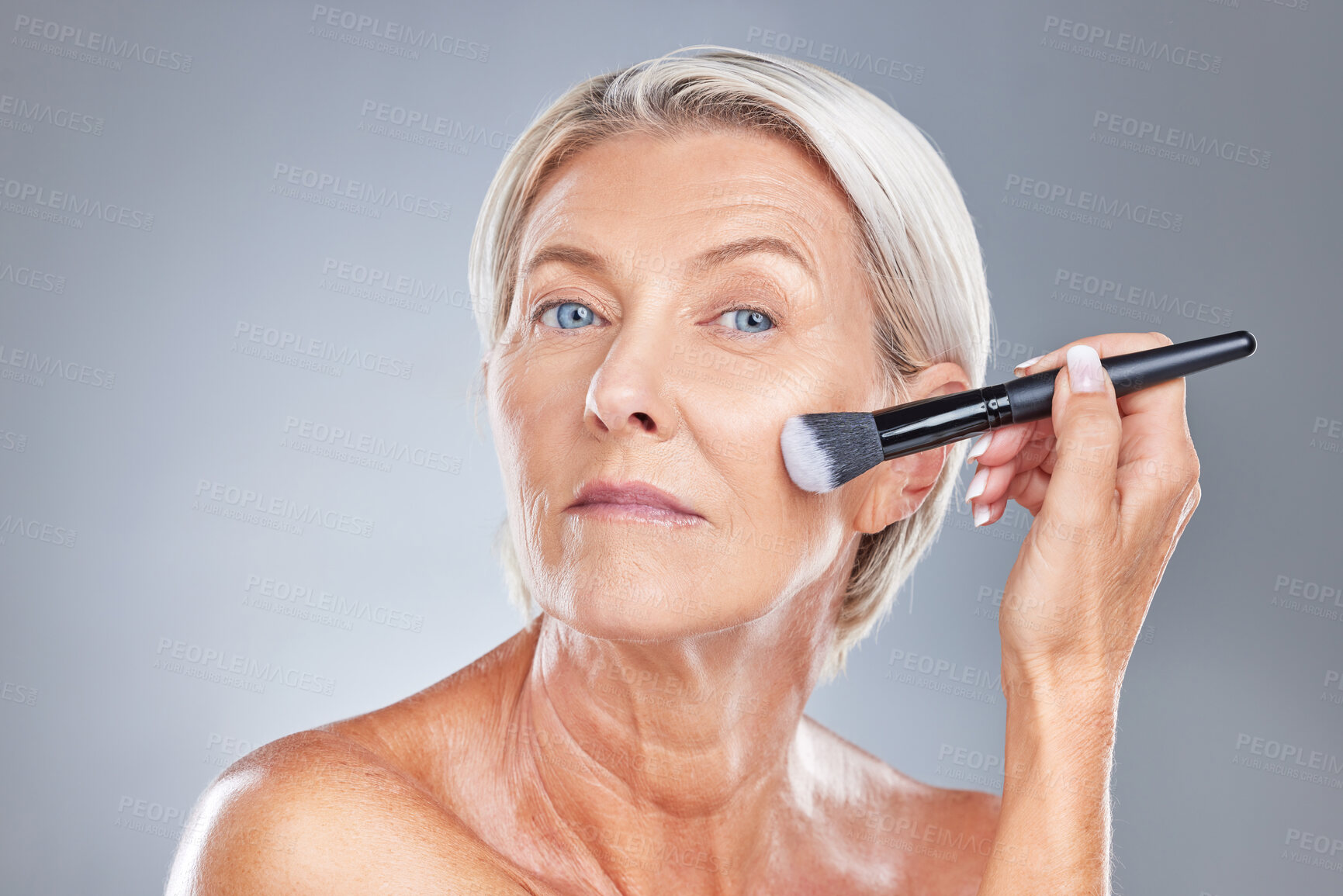 Buy stock photo Makeup, cosmetic brush and woman face of a model with healthy skin, wellness and skincare. Beauty, cosmetics and dermatology treatment of an serious old person from Germany start getting ready