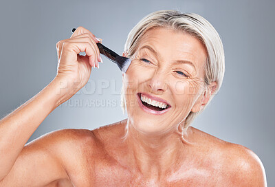 Buy stock photo Happy, senior woman and makeup brush in studio for beauty, skincare and wrinkles treatment on a grey background. Face, cheek and product by elderly model happy, excited and smiling about cosmetics
