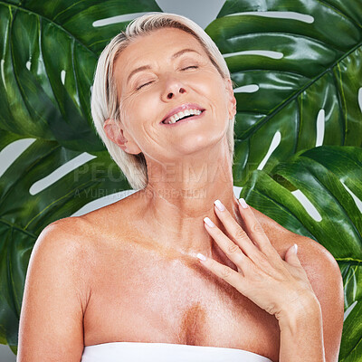 Buy stock photo Beauty, skincare and senior woman in a studio with an anti aging, natural and organic face routine. Happy, smile and elderly lady with a cosmetic wellness facial treatment isolated by leaf background