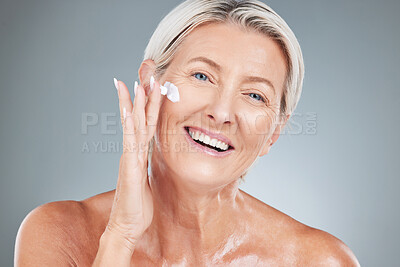 Buy stock photo Beauty, senior and portrait of woman with cream on face for skincare, health and cosmetic antiaging. Happy, mature and natural cosmetics for skin model advertising with gray studio mockup.

