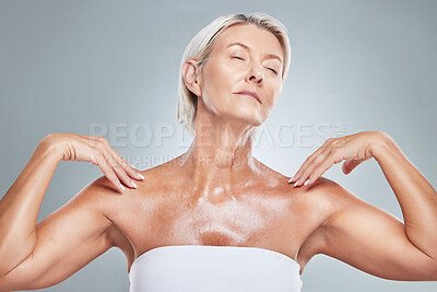 Buy stock photo Skincare, skin and senior woman in studio for beauty, grooming and wellness against a grey background. Relax, body and elderly model posing with shine, glow and healthy skin after anti aging product