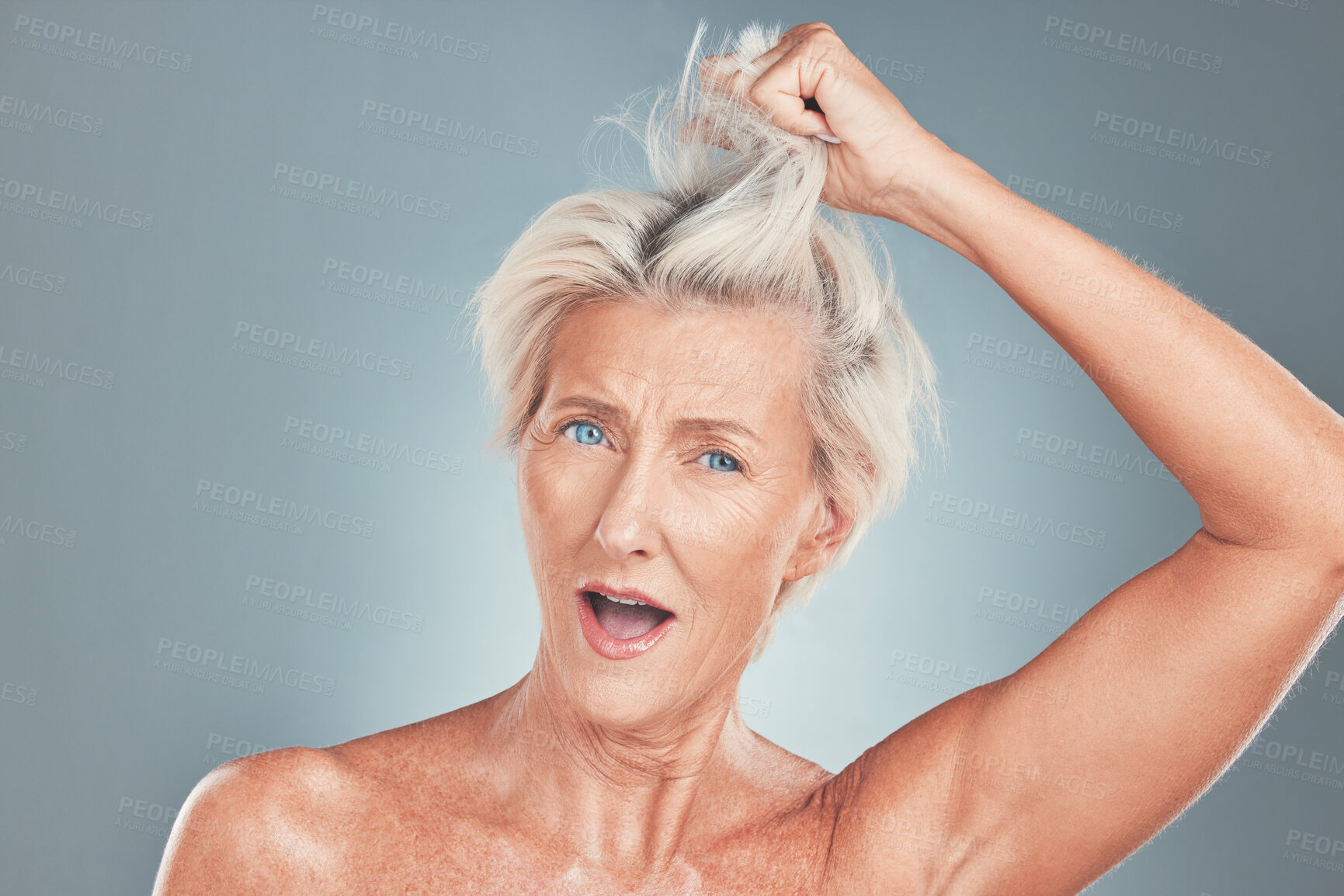 Buy stock photo Senior, woman and hair with wow face in studio for cosmetics, beauty and wellness against blue background. Elderly model, surprised and hair care with makeup, cosmetic and hairstyle against backdrop