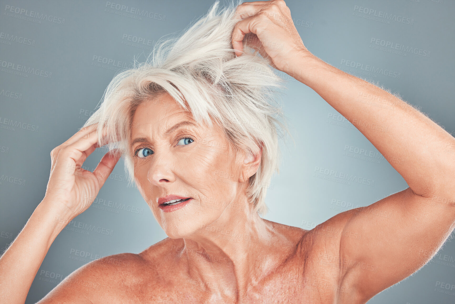 Buy stock photo Senior woman, messy hair and stress for salon care, cosmetics or cut against a grey studio background. Portrait of elderly female having a bad hair day looking for makeover or cosmetic treatment