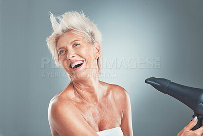 Buy stock photo Hair, hairdryer and senior woman in studio for beauty, stylish and hair care on grey background mockup. Grey hair, mature woman and elderly woman wellness model dry hair, happy, relax and having fun