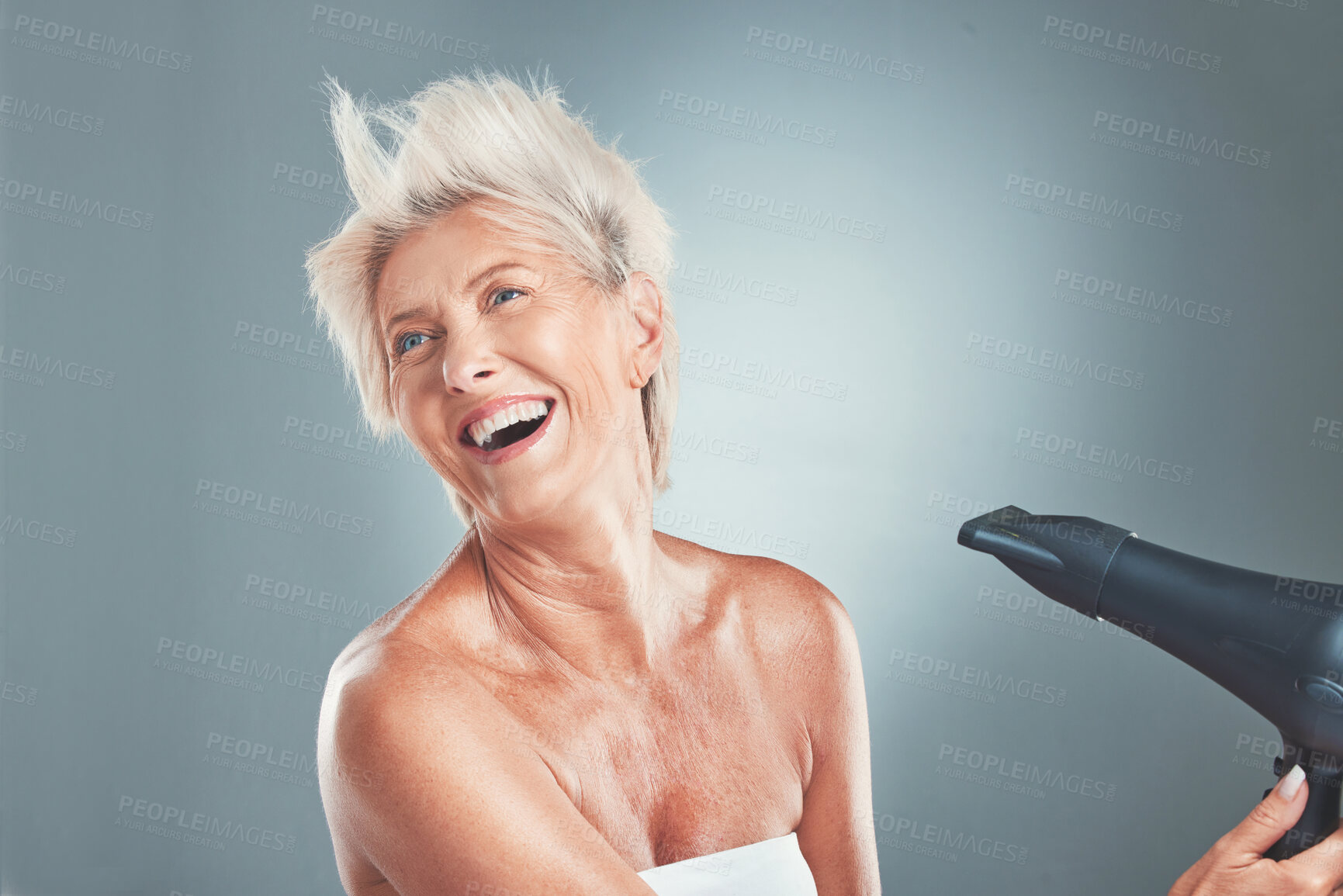 Buy stock photo Hair, hairdryer and senior woman in studio for beauty, stylish and hair care on grey background mockup. Grey hair, mature woman and elderly woman wellness model dry hair, happy, relax and having fun