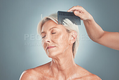 Buy stock photo Senior woman, beauty and hand comb hair for cosmetic care or wellness treatment. Elderly person, closed eyes and arm brushing healthy short locks for natural healthcare in blue backgriund studio