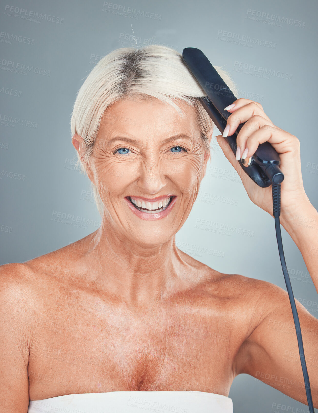 Buy stock photo Portrait of an old woman in studio with a hair iron for grooming, hair care treatment and salon hairstyle. Beauty, self care and happy elderly person hairdressing with a hair straightener for shine