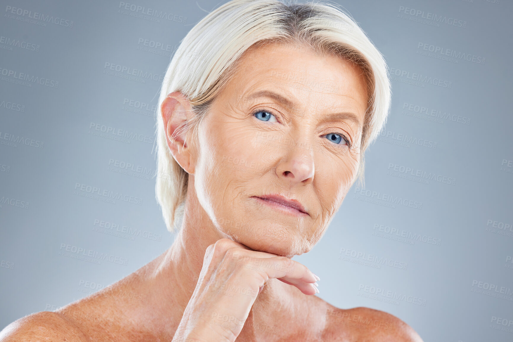 Buy stock photo Face, beauty and skincare with a senior woman in studio on a gray background for antiaging treatment. Cosmetics, luxury and natural with a mature female posing to promote a body care product