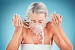 Water splash, skincare and bathroom face routine of a senior woman with hands throwing water. Beauty, cosmetic and skin wellness health routine of an elderly person ready for a dermatology treatment