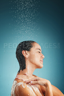 Buy stock photo Shower, water splash and woman cleaning, hair and wellness, grooming and hair care in a studio with mockup. Beauty splash, relax and hair care by asian girl cleaning, skin and hair on blue background