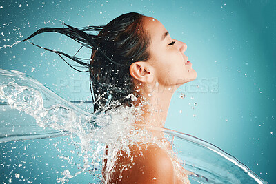 Buy stock photo Hair care, water and woman cleaning body for health, skincare and happiness against blue mockup studio background. Beauty, cosmetics and Asian model with splash for washing hair and wellness at a spa