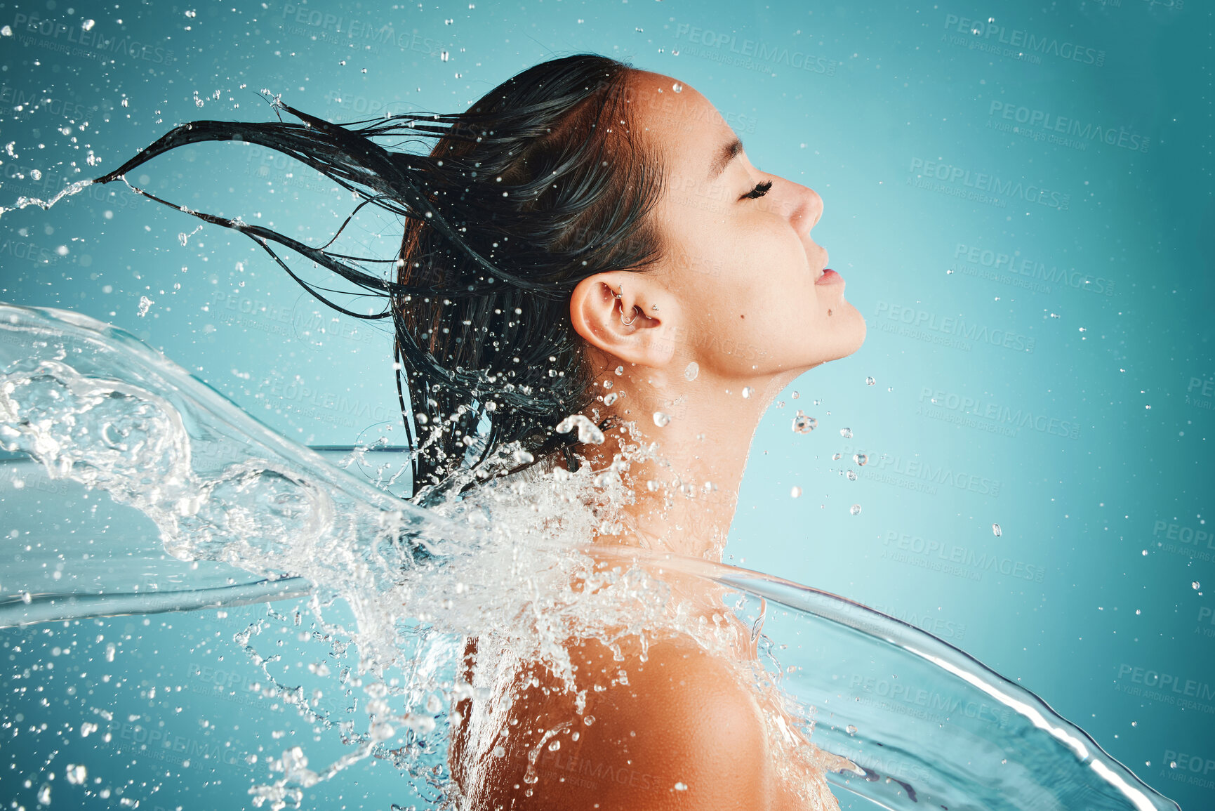 Buy stock photo Hair care, water and woman cleaning body for health, skincare and happiness against blue mockup studio background. Beauty, cosmetics and Asian model with splash for washing hair and wellness at a spa