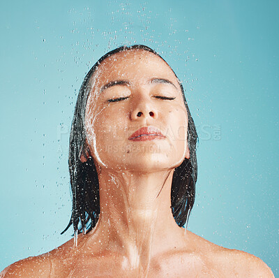 Buy stock photo Beauty, asian and woman in shower with face in water for wellness, self care and body hygiene. Health, cleaning and satisfaction of girl washing with blue studio mockup for cosmetic marketing.

