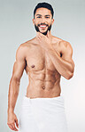 Skincare, beauty and portrait of man with towel on waist in studio on white background. Wellness, body care and male model pose for for facial, skincare products and hygiene for washing and cleaning