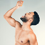 Orange, juice and man eating fruit for health, nutrition and clean diet against a grey studio background. Citrus, food and healthy person with smile and happy about vitamin c for care for body