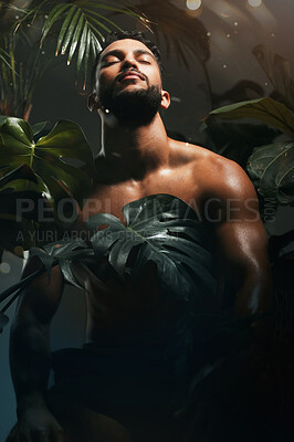 Buy stock photo Beauty, skincare and palm leaf with a man model in studio in a rainforest background with trees or plants. Nature, tropical and wellness with a handsome young male posing to promote natural treatment