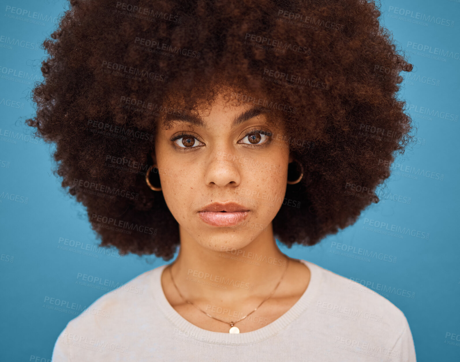Buy stock photo Black woman, natural hair and afro for skincare, hair care and beauty on a blue studio background. Face portrait  or headshot of an African model posing for cosmetic, fashion and self care motivation