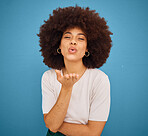 Love, happy and woman blowing kiss for fashion, comic and young lifestyle against blue mockup studio background. Smile, flirty and portrait of African girl model with affection, comedy and happiness