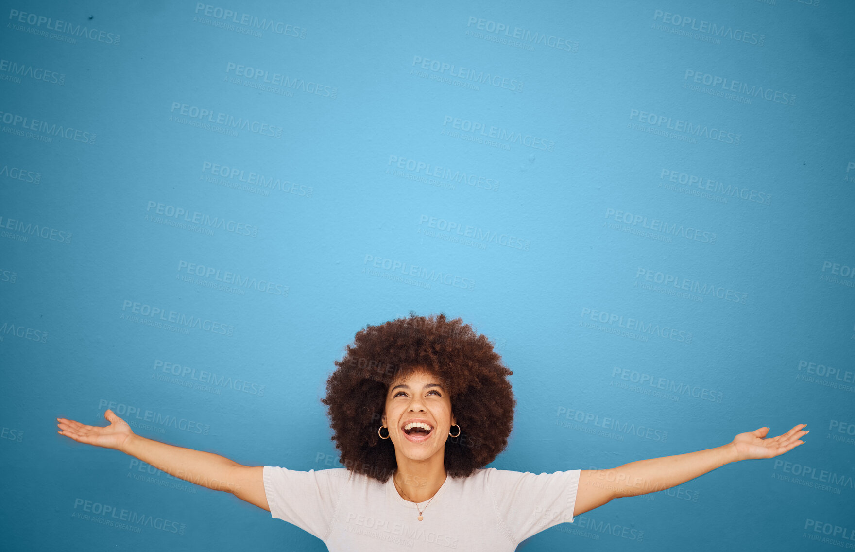 Buy stock photo Winner, mockup and excitement with a black woman in celebration in studio on a blue background for marketing or advertising. Motivation, space and product placement with a female cheering in victory