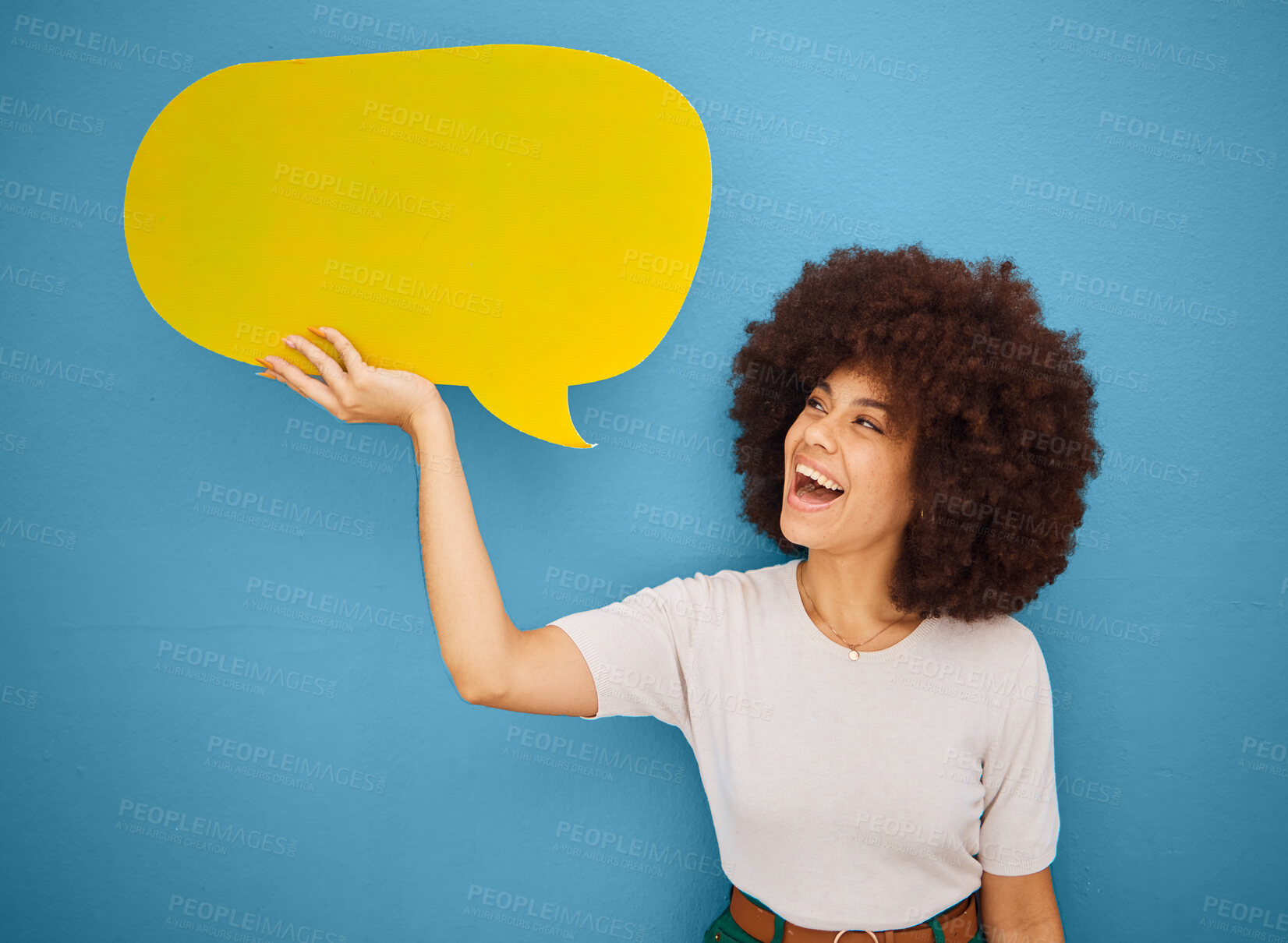 Buy stock photo Black woman with yellow speech bubble, afro and blue background mockup space for advertising or product placement. Smile, announcement sign and woman excited for social media sale launch.