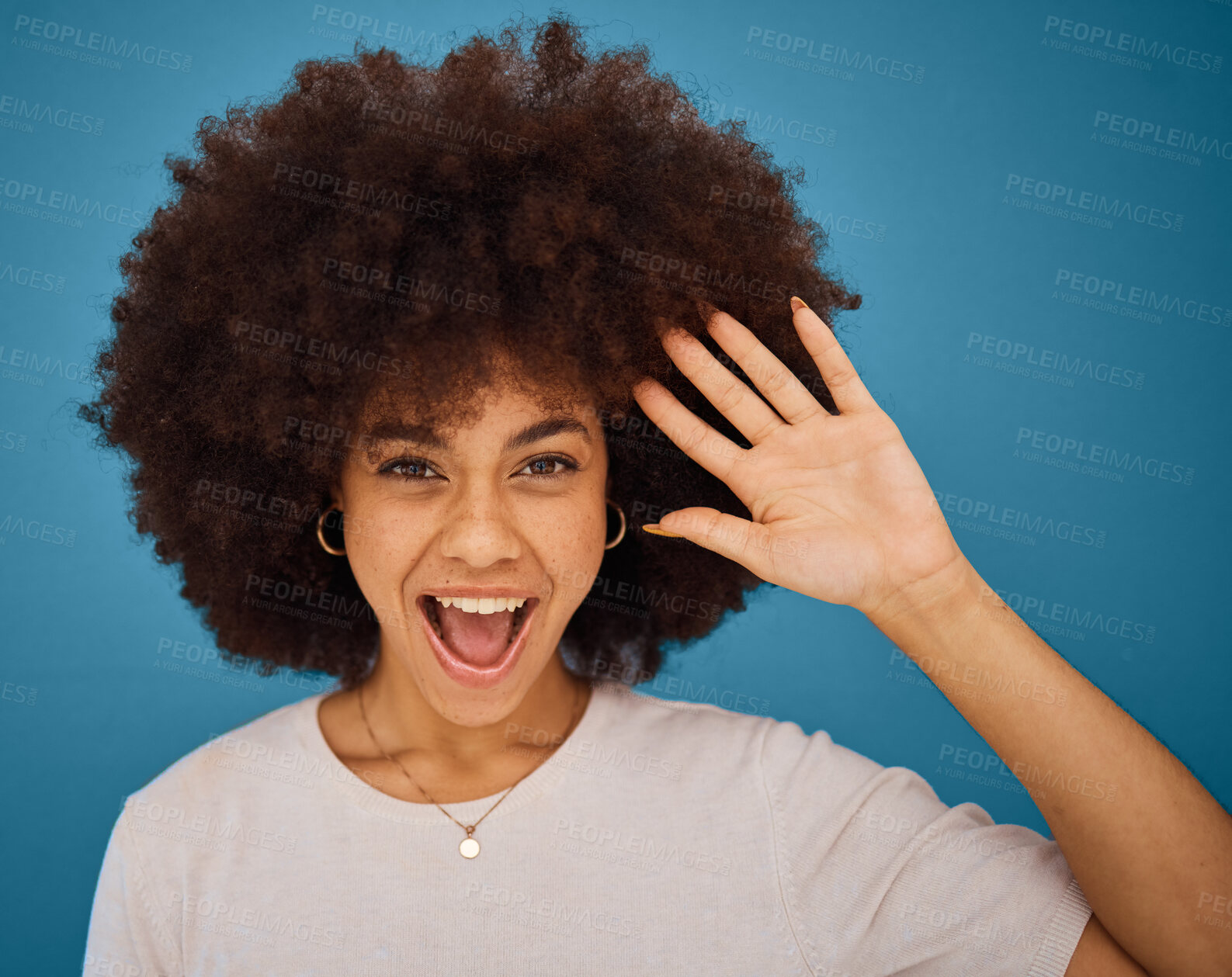 Buy stock photo Brazilian woman, afro or surprise face on blue background in studio in waving, hi or greeting hand gesture. Portrait, smile or happy model and excited or comic facial expression and fashion hairstyle