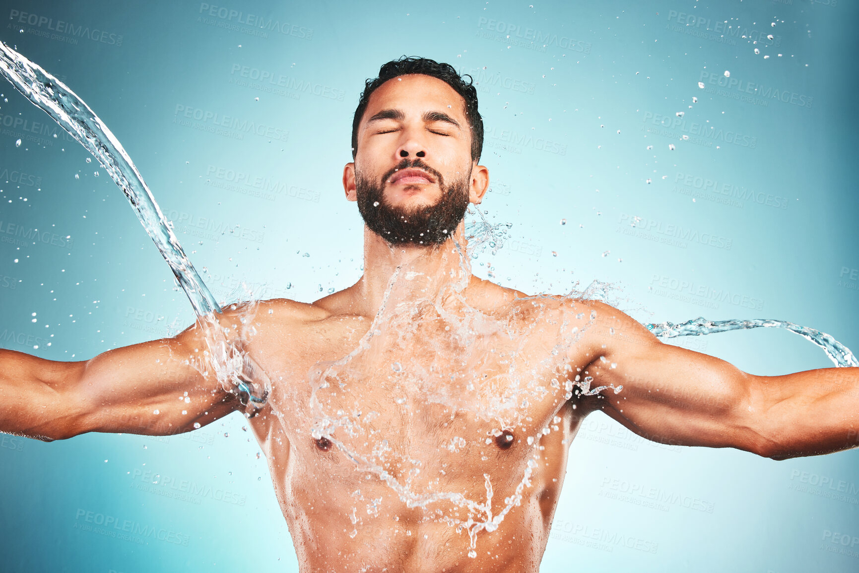 Buy stock photo Muscular man, water splash and wellness for fitness and health with blue studio background. Hygiene, male athlete and bodybuilder wash clean, shower and body care after workout, training and exercise