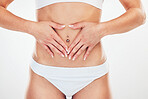 Woman, body and hands on stomach closeup for healthy digestion wellness or beauty lifestyle. Fitness person, healthcare support and hand on abdomen for cosmetic skincare in white background studio