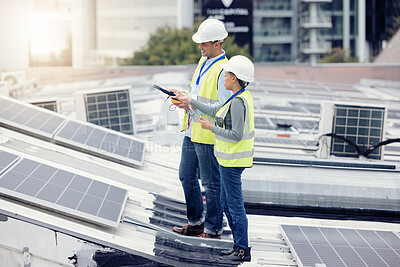 Buy stock photo Sustainable engineering, solar panels and team doing maintenance on the rooftop of building in the city. Solar energy, ecology and industrial workers planning project with photovoltaic cells in town.