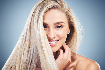 Buy stock photo Hair care, smile and face of a woman with beauty, happy and natural makeup against a blue studio background. Skincare, wellness and portrait of a model with cosmetic body care and clean hair