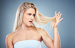 Hair care problem, angry and woman frustrated with damaged hair, split ends or bad haircut. Trichology crisis, hair disaster and model unhappy with hair loss from shampoo routine on studio background