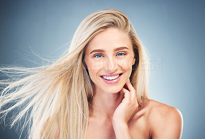 Buy stock photo Beauty, skin care and hair care of a woman in studio for health, wellness and self care with shampoo, makeup and cosmetics. Portrait, face and smile of a model happy about glow from dermatology care