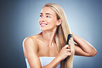 Hair, haircare and woman comb or style for health on a grey studio background. Hairstyle, brush and tool for hair style and wellness, beauty and cosmetic treatment for grooming on a backdrop