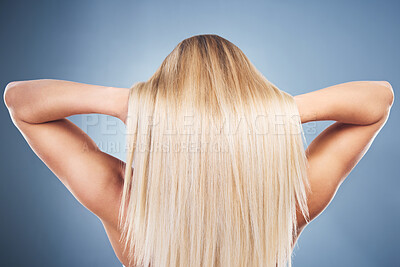 Buy stock photo Beauty, hair and haircare with blonde woman styling hairstyle on a grey studio background for grooming. Hair care, hygiene and hair style for contemporary female from the back on a gray backdrop