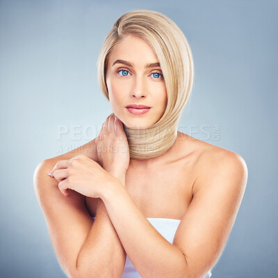 Buy stock photo Portrait, hair care, face and woman with skincare, wellness and natural beauty with blue studio background. Aesthetic, young female and girl confident with hairstyle, blond and pride with cosmetics.