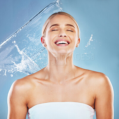 Buy stock photo Water, beauty and cleaning with a model woman in studio on a blue background for hydration in a splash. Shower, skincare and wellness with an attractive young female wet for luxury or hygiene