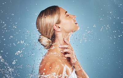 Buy stock photo Skincare, water and profile of woman on blue background in studio for beauty, facial and wellness. Hydration, skincare products and girl model for washing, cleaning and  body cleanse at luxury spa