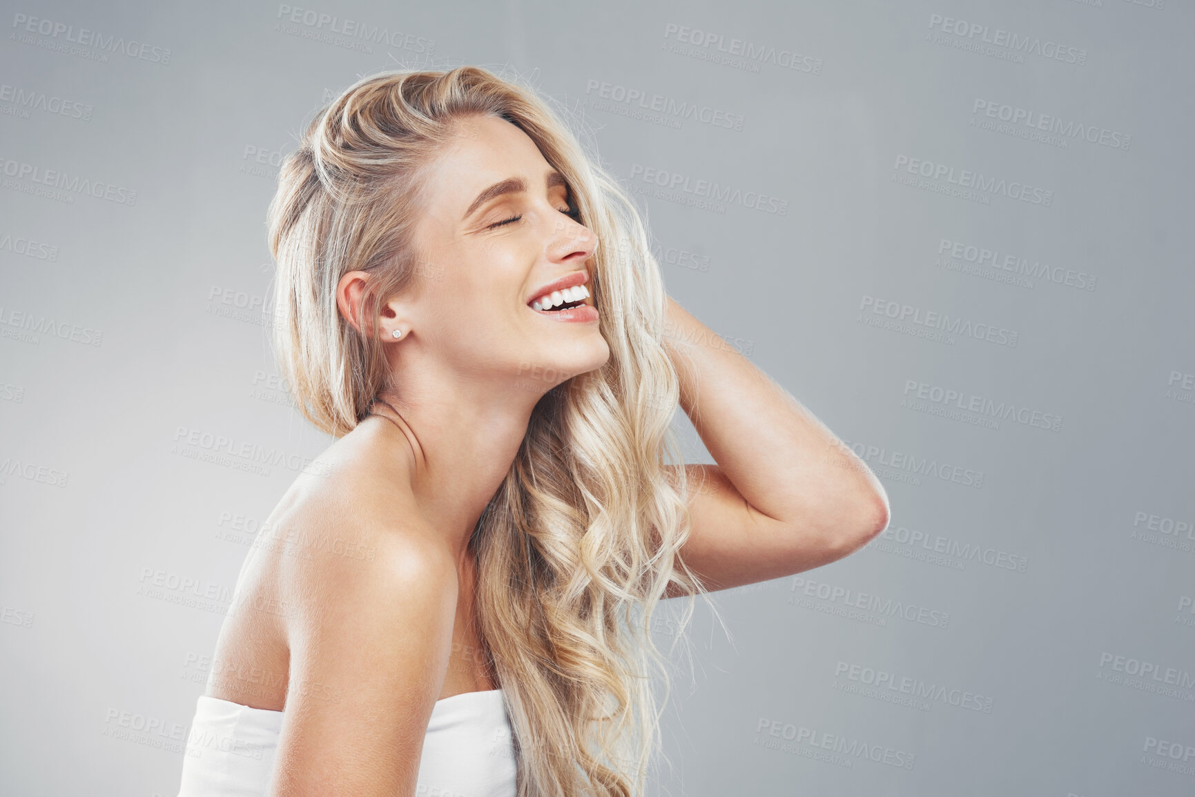 Buy stock photo Hair care, woman and smile being happy, head and confident being content, proud and with grey studio background. Young female, girl or touch hair for wellness, natural beauty or happiness being bare