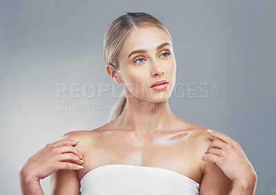 Buy stock photo Beauty, skincare and woman model with a glow while advertising cosmetic, makeup or dermatology product on grey studio background. Face of girl posing for health, wellness and shine on skin and body