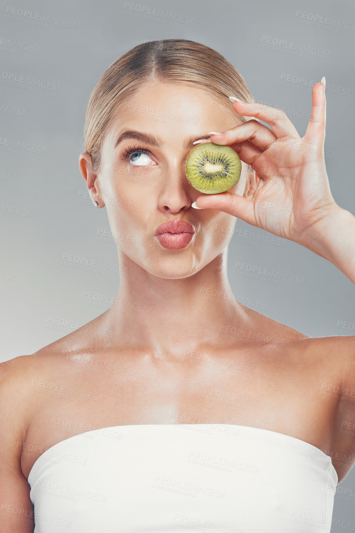 Buy stock photo Thinking, beauty and woman with kiwi face for organic skincare, health and cosmetic product. Thoughtful skin model girl for fruit cosmetic treatment marketing with gray gradient background.