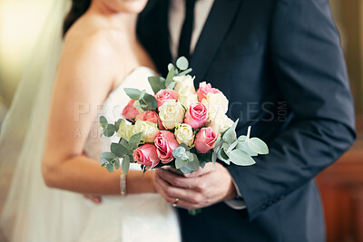 Flower bouquet, wedding celebration and couple together for commitment, love and marriage of bride and groom. Flowers in hands of young man and woman at union event with trust, support and care