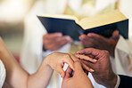 Couple hands with ring, wedding and marriage in church with priest and bible in traditional ceremony. Commitment, love and jewelry, man and woman together with trust and jewellery with bride.